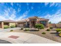 Inviting home with a tile roof, a two-car garage, and low-maintenance landscaping at 18076 W Redwood Ln, Goodyear, AZ 85338