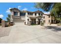 Inviting two-story home with a well-maintained yard and convenient two-car garage at 19820 E Reins Rd, Queen Creek, AZ 85142