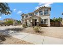 Beautiful two-story home boasts manicured desert landscaping and an attached two-car garage at 19820 E Reins Rd, Queen Creek, AZ 85142