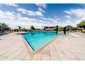 A large community pool with sun loungers and shaded cabanas provides a resort-like experience at 21817 N 39Th St, Phoenix, AZ 85050