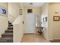 Inviting entryway featuring tile flooring, staircase, and a charming console table at 26408 N 53Rd Gln, Phoenix, AZ 85083