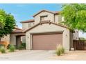 Exterior view of a two-story home featuring a two-car garage, neutral stucco, and manicured landscaping at 27289 N 90Th Ave, Peoria, AZ 85383