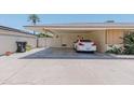 Spacious carport featuring brick walls and a paved driveway, offering covered parking and convenience at 323 E Griswold Rd, Phoenix, AZ 85020