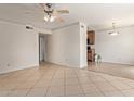 Living area with tile flooring and ceiling fan transitioning to the kitchen at 3500 N Hayden Rd # 1603, Scottsdale, AZ 85251