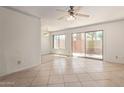 Open floor plan with tile flooring, ceiling fan, and sliding glass door to the outdoors at 3500 N Hayden Rd # 1603, Scottsdale, AZ 85251