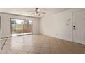Bright living room featuring tile flooring, ceiling fan, and sliding glass door to a patio at 3500 N Hayden Rd # 1603, Scottsdale, AZ 85251