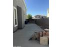 A tidy side yard featuring a concrete pathway, brick accents, and a secure wooden gate for enhanced privacy at 4151 E Campbell Ave, Gilbert, AZ 85234