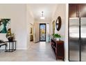 Bright, open foyer with tile flooring, decorative mirror, and seamless flow into the living spaces at 4611 E Red Bird Rd, Cave Creek, AZ 85331