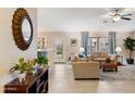 Inviting living room with neutral tones, tile floors, backyard access, and stylish furnishings at 4611 E Red Bird Rd, Cave Creek, AZ 85331
