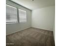 Bright bedroom with plush carpeting and large windows for natural light at 46922 W Coe St, Maricopa, AZ 85139