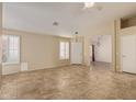 Inviting living room with tiled floors, plantation shutters, and neutral color palette at 5336 W Campo Bello Dr, Glendale, AZ 85308