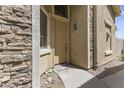 Inviting front entryway with stone accents, a welcome mat, and a charming light fixture at 5415 E Mckellips Rd # 100, Mesa, AZ 85215