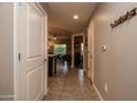 Hallway featuring tile flooring, neutral walls, and a glimpse of the kitchen and dining area at 5450 E Deer Valley Dr # 1176, Phoenix, AZ 85054