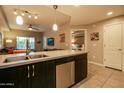 Open concept kitchen with stainless steel appliances, island with sink, and view into the living room at 5450 E Deer Valley Dr # 1176, Phoenix, AZ 85054