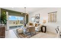Cozy living room with neutral tones, stylish furniture, and a sliding glass door leading to the backyard at 5530 E Mearn Rd, San Tan Valley, AZ 85140