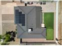 Aerial view showcasing solar panels, back patio area with putting green, artificial turf, and spacious backyard at 7320 E Pierce St, Scottsdale, AZ 85257
