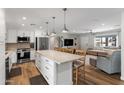 Open-concept kitchen featuring a large center island, stainless steel appliances, and adjacent living area at 7320 E Pierce St, Scottsdale, AZ 85257