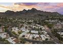 Panoramic aerial view of a residential area nestled against a mountain range, showcasing the neighborhood's layout at 7714 N 17Th Pl, Phoenix, AZ 85020