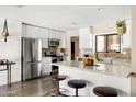 Modern kitchen boasts stainless steel appliances, granite countertops, and ample cabinet space at 8502 E Rose Ln, Scottsdale, AZ 85250