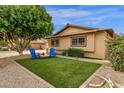 Charming backyard area with artificial turf, perfect for seating, complemented by gravel and well-maintained landscaping at 8644 E Roanoke Ave, Scottsdale, AZ 85257