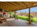 Inviting covered patio with brick flooring, string lights, and a view of the landscaped backyard, ideal for relaxing at 8644 E Roanoke Ave, Scottsdale, AZ 85257