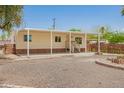 Charming single-story home with a covered porch and landscaped yard, blending comfort and curb appeal in a desert setting at 9710 E Baywood Ave, Mesa, AZ 85208