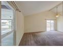 Bright living room with vaulted ceilings and sliding glass doors for natural light at 9710 N 55Th Ave, Glendale, AZ 85302