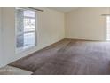 Bright living room with neutral walls, plush carpet, and ample natural light at 9710 N 55Th Ave, Glendale, AZ 85302