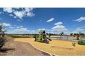 Fun playground featuring swings, slides, and climbing structures in a safe, landscaped area at 9827 W Agora Ln, Tolleson, AZ 85353