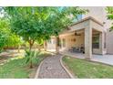 Great outdoor living space with covered patio, manicured lawn, and mature trees at , Gilbert, AZ 85234