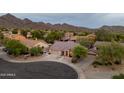 An aerial view of the property showcasing a home with a tile roof and desert landscaping at 10527 E Acacia Dr, Scottsdale, AZ 85255