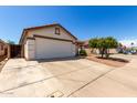 Exterior view featuring a spacious driveway leading to the attached two-car garage at 1116 S 53Rd St, Mesa, AZ 85206
