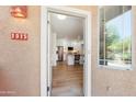 Inviting front entry showcasing modern door, neutral stucco and a glimpse of the home's open-concept interior at 11500 E Cochise Dr # 1015, Scottsdale, AZ 85259