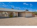 Charming single-story brick home with a two car garage and gravel landscaping at 1225 E Jacob Ln, Phoenix, AZ 85020