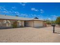 Charming single-story brick home with a two car garage and gravel landscaping at 1225 E Jacob Ln, Phoenix, AZ 85020