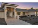 Striking front entrance with grand columns, contemporary lighting, and a paved walkway, enhancing curb appeal at 13365 N 74Th St, Scottsdale, AZ 85260