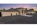 Contemporary home showcasing a welcoming entrance with modern lighting and meticulous desert landscaping at 13365 N 74Th St, Scottsdale, AZ 85260