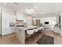 Bright kitchen features an island with marble countertop, seating, and pendant lights at 13365 N 74Th St, Scottsdale, AZ 85260