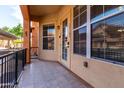 Spacious front porch featuring tile flooring, large windows, and a secure entrance door at 14575 W Mountain View Blvd # 12107, Surprise, AZ 85374