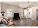 Cozy living room featuring plantation shutters, modern flooring, and entertainment area at 14624 N 90Th Ln, Peoria, AZ 85381