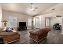 Bright living room with vaulted ceilings, plantation shutters, and a ceiling fan at 14624 N 90Th Ln, Peoria, AZ 85381