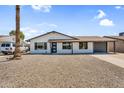 Single-story house with low-maintenance landscaping, a long driveway, and attached garage, offering convenience and curb appeal at 14635 N 37Th Pl, Phoenix, AZ 85032