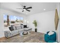 Bright living room with large windows, comfortable seating, and a modern aesthetic, perfect for relaxing and entertaining at 14635 N 37Th Pl, Phoenix, AZ 85032