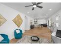 Open concept living and dining area with hardwood floors, chic decor, and an inviting atmosphere at 14635 N 37Th Pl, Phoenix, AZ 85032