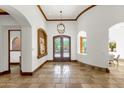 Elegant foyer with travertine flooring, wood beam accents, and decorative lighting at 14760 E Paradise Dr, Fountain Hills, AZ 85268