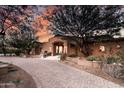 Stunning single-story home featuring a circular driveway and desert landscaping at 14760 E Paradise Dr, Fountain Hills, AZ 85268