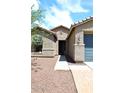 Close up of home's entrance with well-manicured landscaping leading to the front door at 16418 W Whitehorn Way, Surprise, AZ 85387