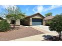 Inviting home showcasing desert landscaping, neutral exterior, and a spacious driveway at 16418 W Whitehorn Way, Surprise, AZ 85387
