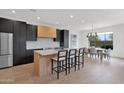 Modern kitchen featuring stone countertops, stainless steel appliances, and an open design with barstool seating at 19550 N Grayhawk Dr # 1039, Scottsdale, AZ 85255