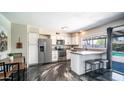 Bright kitchen features stainless steel appliances, modern countertops, and a breakfast bar with seating at 2139 W Obispo Ave, Mesa, AZ 85202